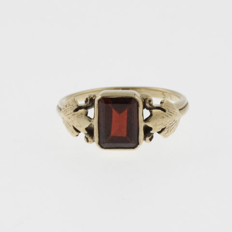 Vintage style emerald cut garnet yellow gold ring with leaf detail