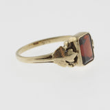 Vintage style emerald cut garnet yellow gold ring with leaf detail